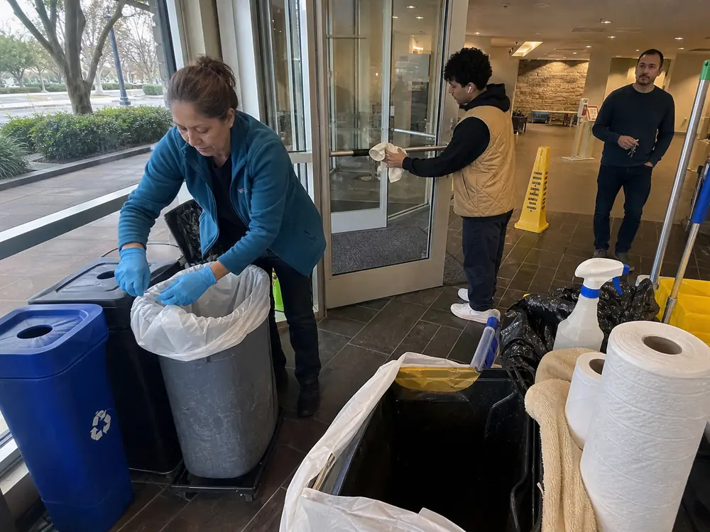 Cleanup crew reviewing job notes at a worksite table