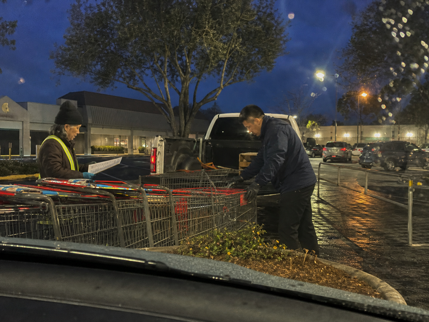Crew collecting shopping carts and loose litter from a parking lot